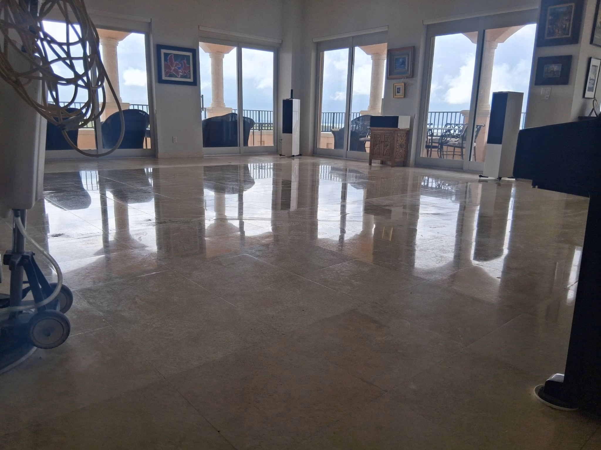 Travertine floor in a Coral Gables home before restoration, dull and worn stone