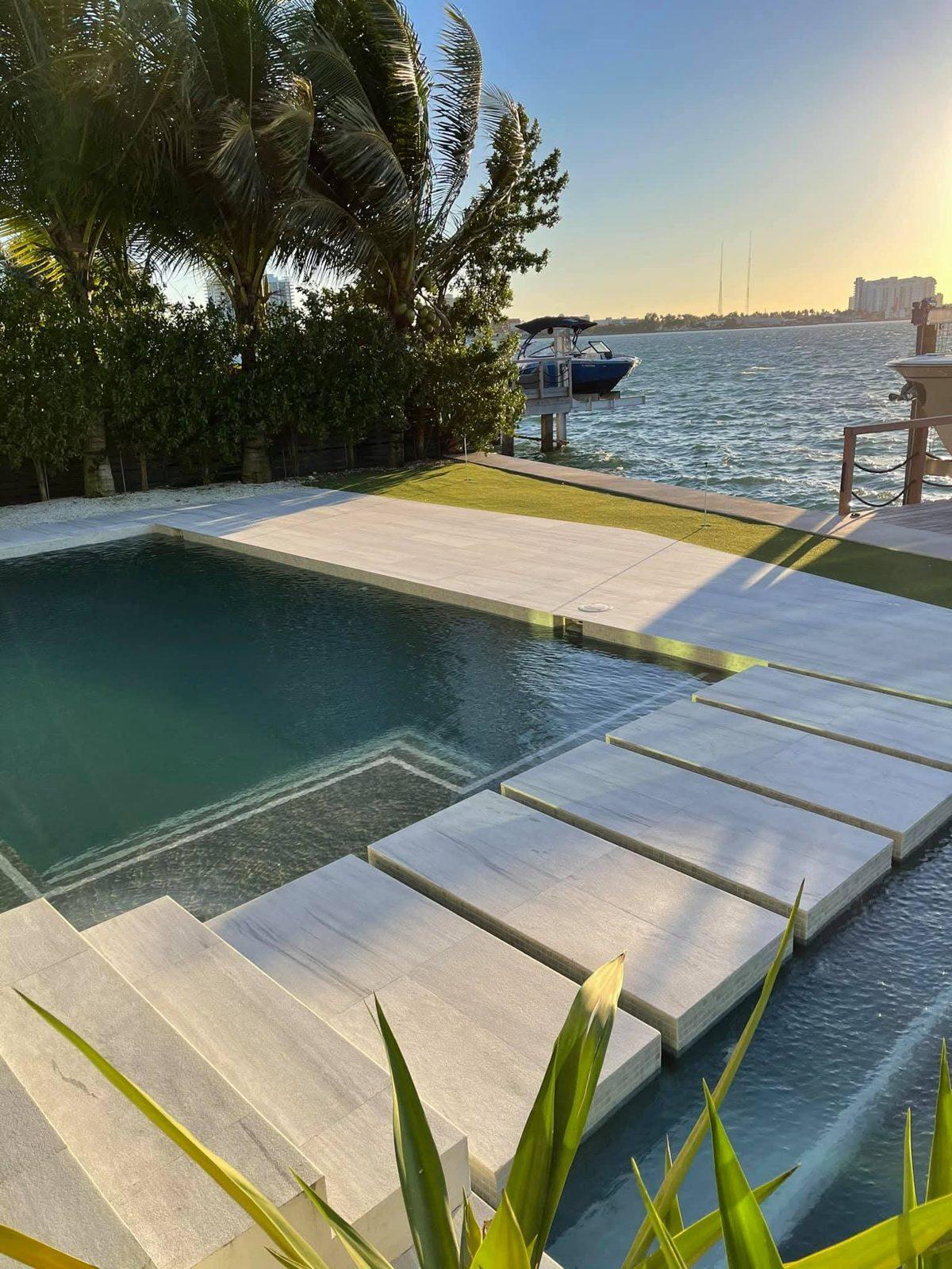 Natural stone pool deck on the bay in Miami after penetrating stone sealing
